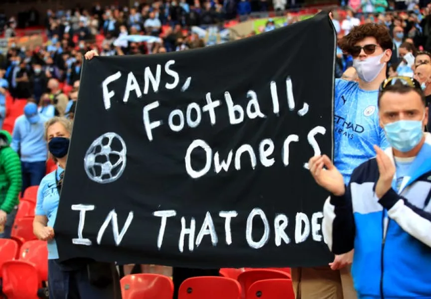Manchester City fans at Wembley hold up a banner protesting against the European Super League