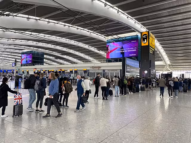 Passengers queuing to go through security in departures at Terminal 5 (Steve Parsons/PA)