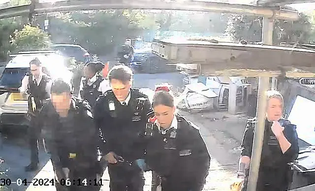 Police officers after tasering and detaining a man