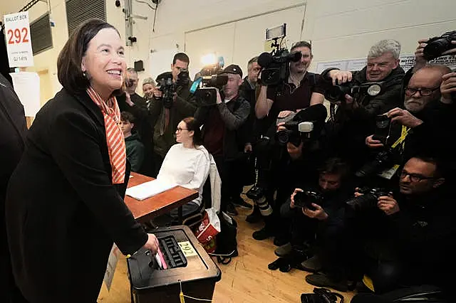 Mary Lou McDonald faces a wall of photographers and reporters as she dropped her vote into the ballot box