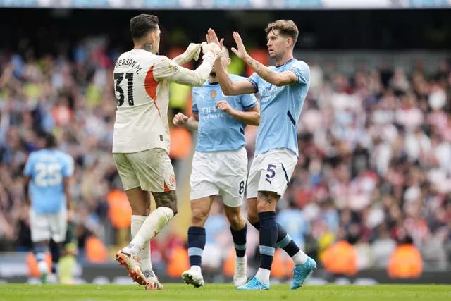 Manchester City’s John Stones (right) and goalkeeper Ederson celebrate after their side score against Brentford