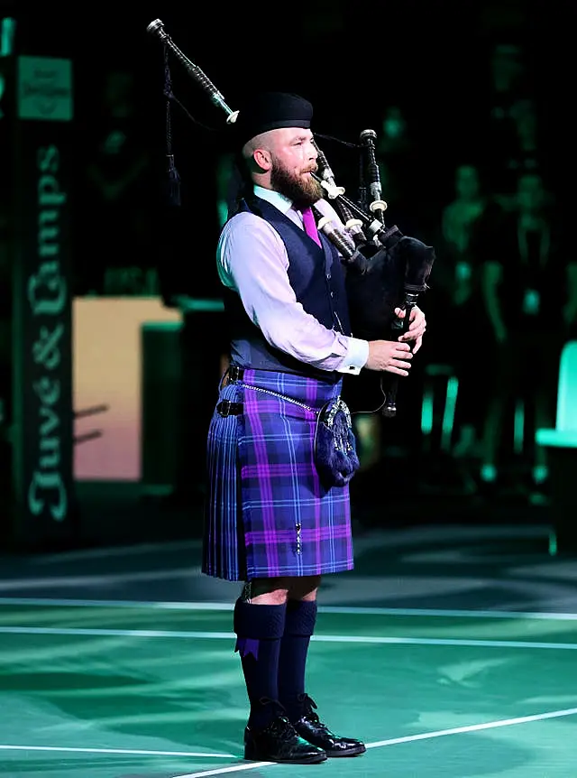 A lone piper played a tribute to the Queen before the tie