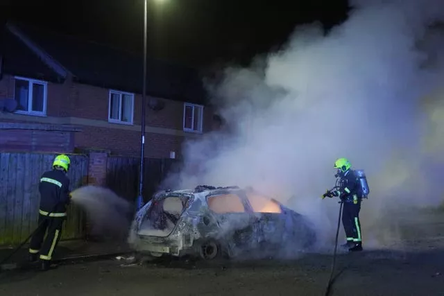 Firefighters tend to a burning police car in Hartlepool