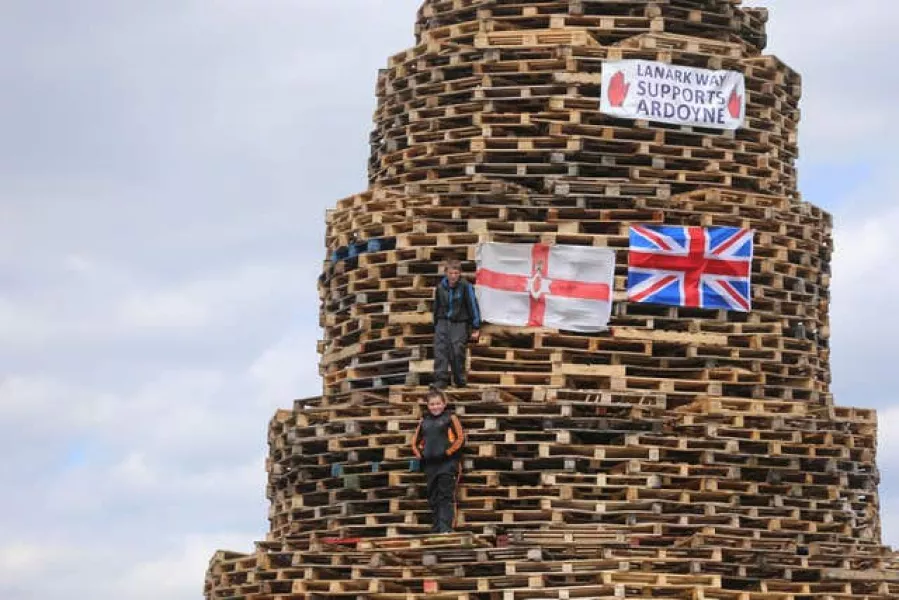 Bonfire builders in the New Mosley area of Belfast