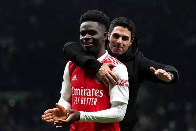 Arsenal’s Bukayo Saka (left) celebrates with manager Mikel Arteta