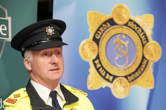 Superintendent Darren McCarthy speaking in front of Garda signage