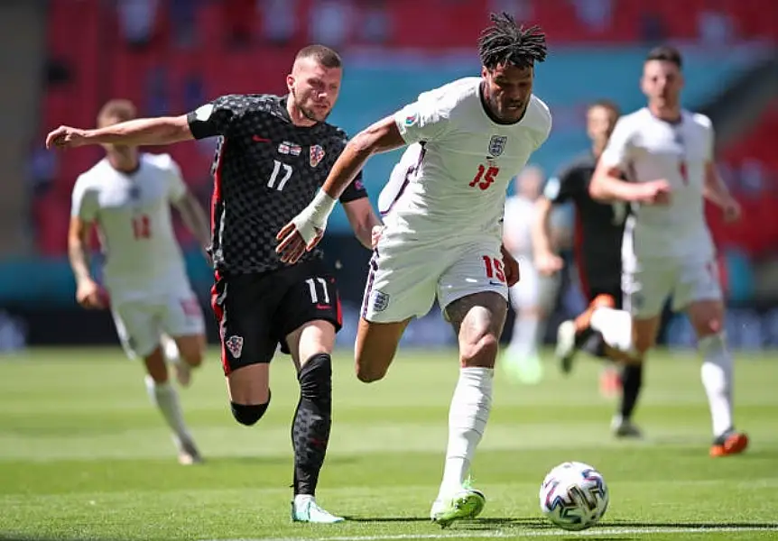 Tyrone Mings shields the ball from Croatia’s Ante Rebic, left