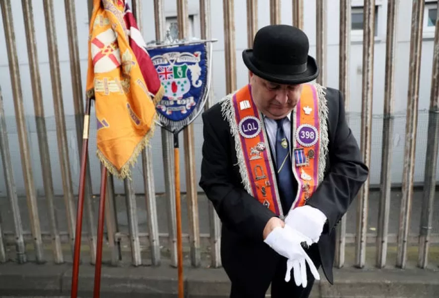 Bandsmen and Orange Order members gather ahead of a parade in Belfast, as part of the annual Twelfth of July celebrations 
