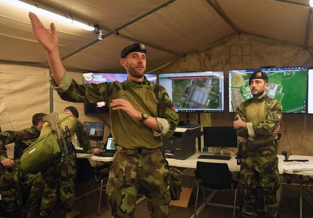 Soldiers in an army tent with screens and monitors at Gormanstown Camp