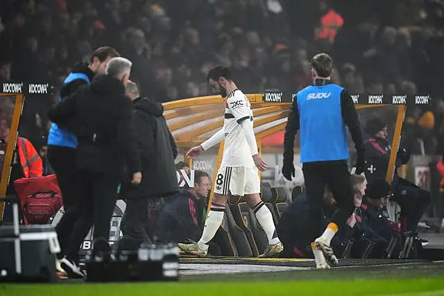 Bruno Fernandes (centre) heads down the tunnel after being sent off 