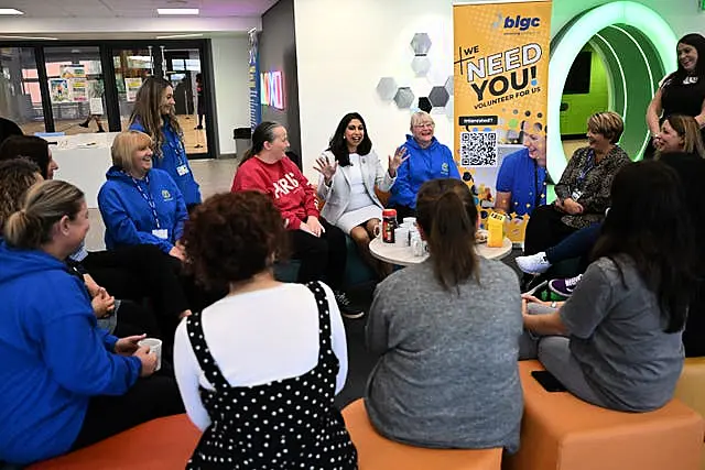 Home Secretary Suella Braverman speaks to volunteers during a visit to Bolton Lads and Girls Club in Bolton, Greater Manchester