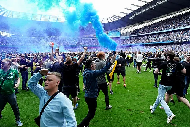 Manchester City scored three times in a madcap six-minute period, prompting thousands of fans to spill on to the pitch at full-time (Martin Rickett/PA)