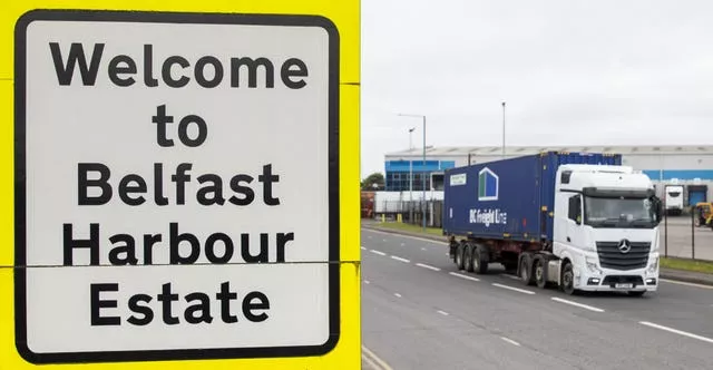 A haulage lorry drives past a sign at Belfast Port