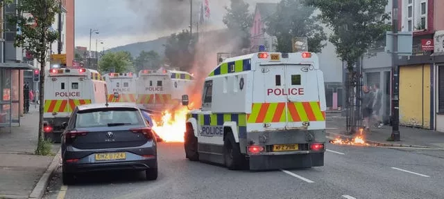 Police vehicles block a road in Belfast