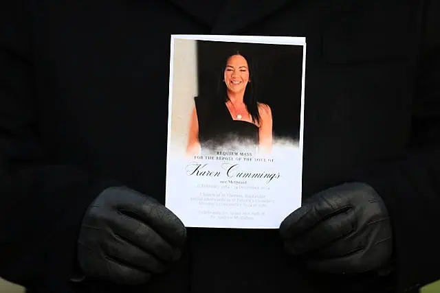 A mourner holds an Order of Service at the funeral of Karen Cummings