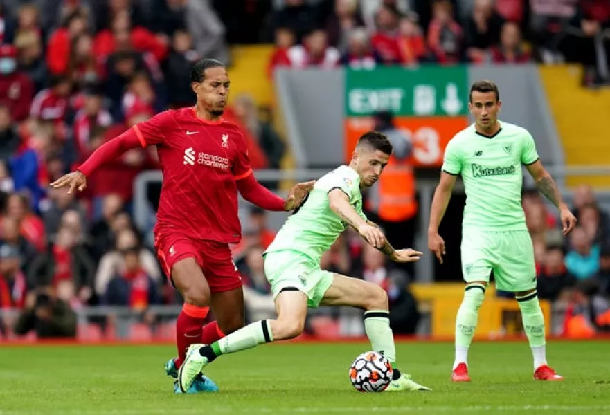 Virgil Van Dijk challenges a Bilbao player for the ball