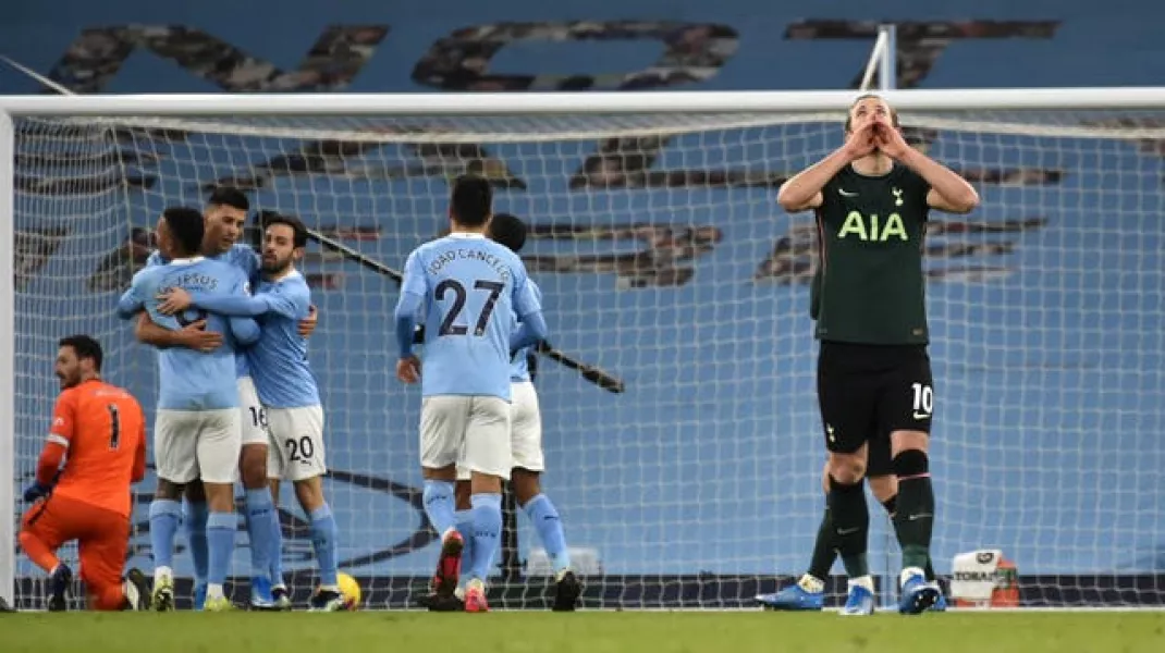 Harry Kane, right, looks dejected after Tottenham concede to Manchester City