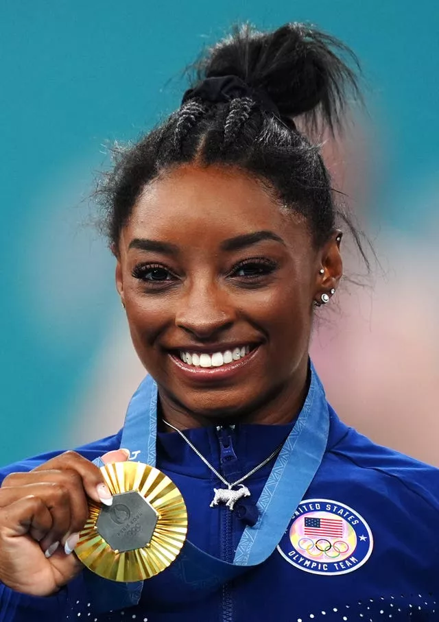 USA’s Simone Biles with her gold medal and sporting a silver goat necklace