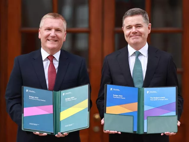 Former minister for finance Michael McGrath and Minister for Public Expenditure Paschal Donohoe holding copies of the Irish budget