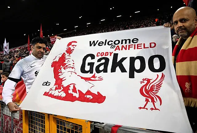 Liverpool fans hold up a banner welcoming the signing of Cody Gakpo