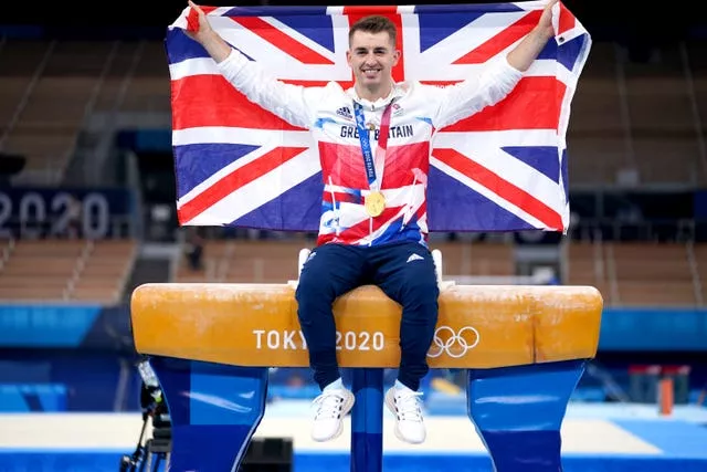 McClenaghan will take on Great Britain's defending Olympic pommel horse champion Max Whitlock poses on top of his apparatus wearing his gold medal and hoisting a Union Flag at the Tokyo 2020 Olympics