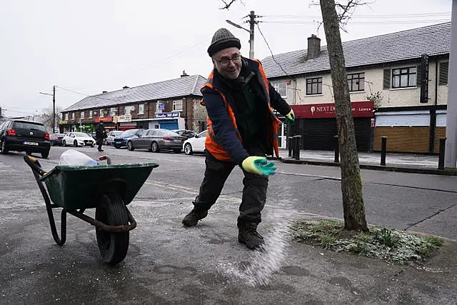 Park Services workers from Dublin City Council gritting footpaths in Ballygall in Dublin ahead of a Status Orange low temperature warning issued for most counties on Wednesday night