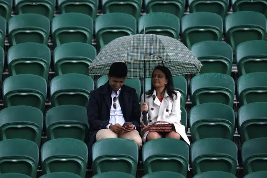 Spectators at Wimbledon also had to contend with the British summer weather
