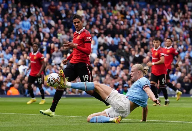 Erling Haaland, right, scores Manchester City’s third goal against United at the Etihad Stadium in October as Raphael Varane looks on