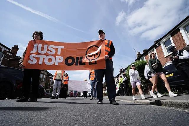 Activists take part in a slow walk protest near Wimbledon Magistrates’ Court 