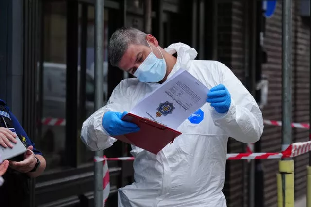 A police forensic investigator looking at papers