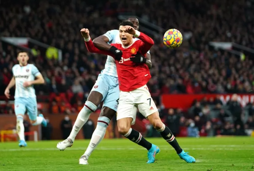 Cristiano Ronaldo, front, goes down under Kurt Zouma's challenge in the Premier League game against West Ham