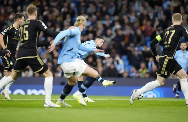 Phil Foden takes a shot with his left foot