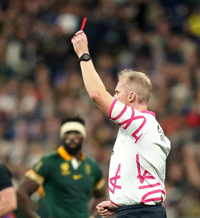 Referee Wayne Barnes shows a red card to New Zealand’s Sam Cane 