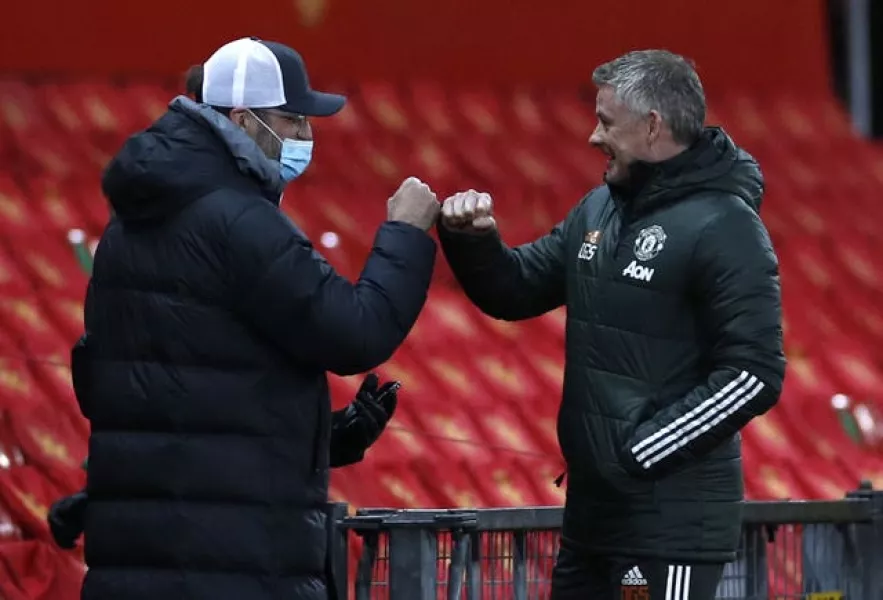 Liverpool manager Jurgen Klopp, fistbumps Manchester United manager Ole Gunnar Solskjaer, right 