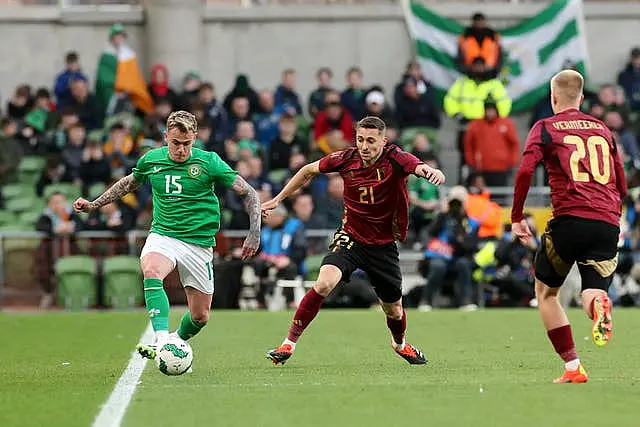 Sammie Szmodics, left, plays a pass under pressure from Belgium's Timothy Castagne