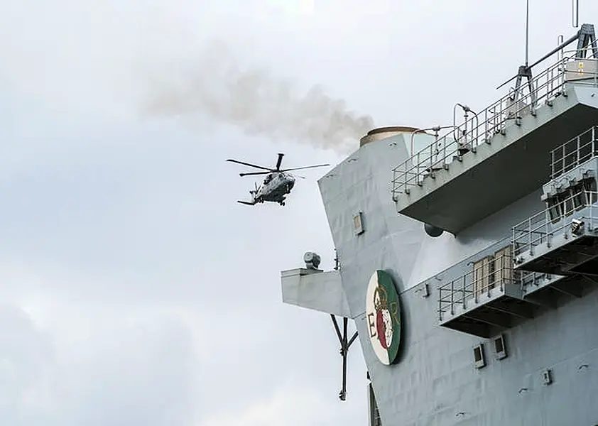 A Royal Navy Merlin helicopter lands on the HMS Queen Elizabeth 