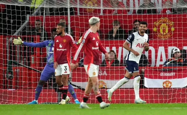 Dominic Solanke celebrates his goal as Manchester United players look on in despair