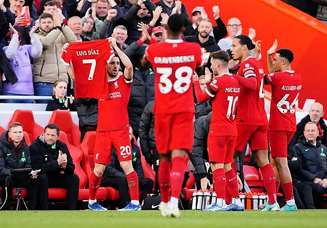 Liverpool’s Diogo Jota celebrates a goal by displaying Luis Diaz’s shirt