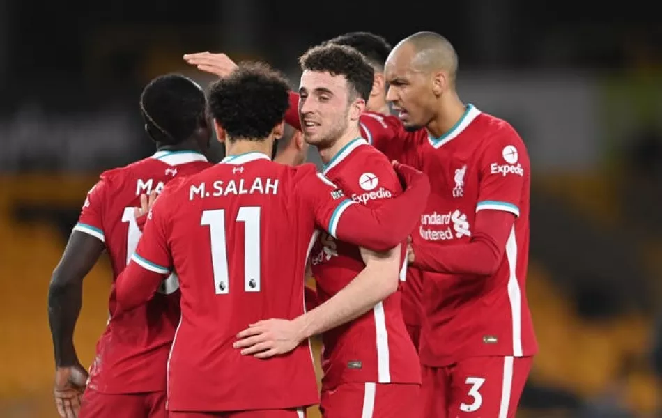 Liverpool’s Diogo Jota celebrates with Mohamed Salah and Fabinho after scoring against Wolves