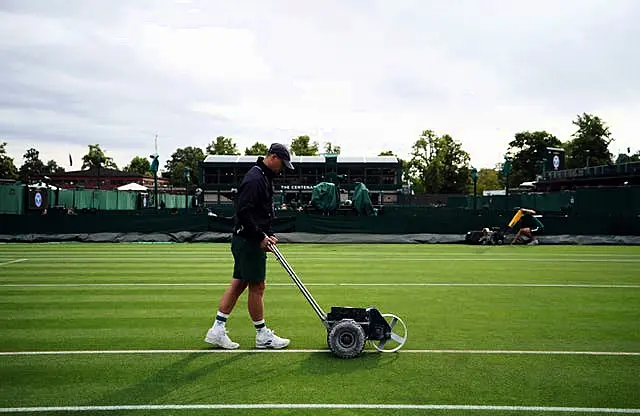 Ground staff preparing court on day two