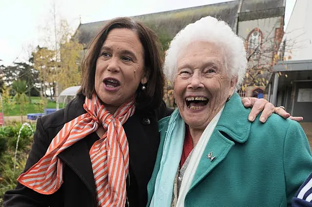 Mary Lou McDonald laughs with an elderly woman