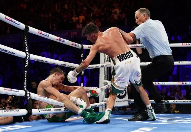 Michael Conlan falls out of the ring after being knocked out by Leigh Wood