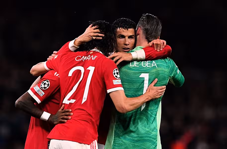Cristiano Ronaldo is mobbed by his team-mates