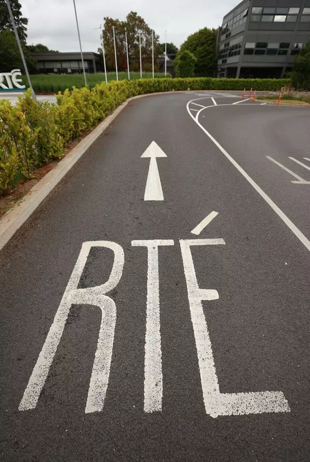 A road with 'RTE' and an arrow painted on it, directing towards a building