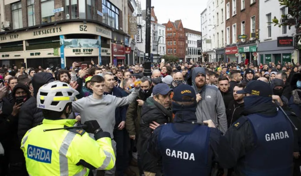 Gardai talk to protesters during an anti-lockdown protest in Dublin city centre