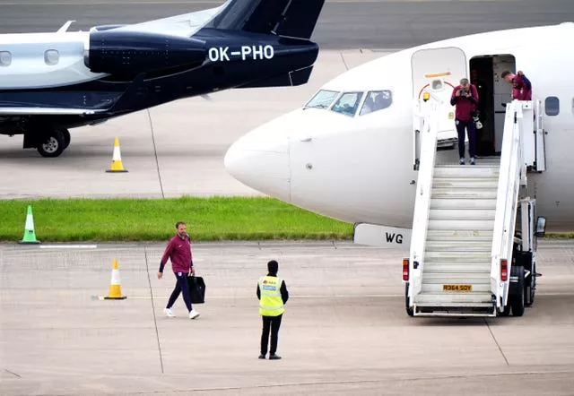 England manager Gareth Southgate prepares to board the plane to Germany