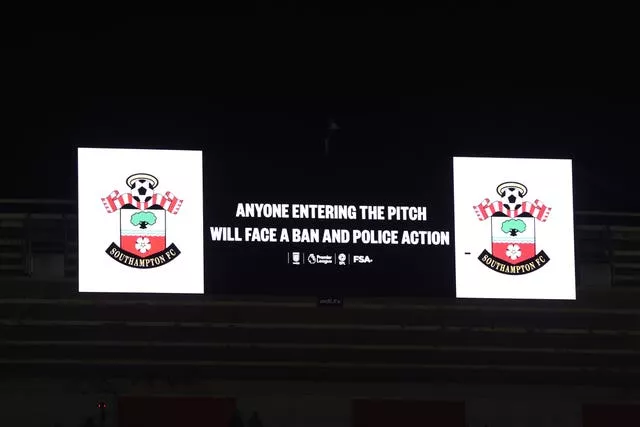 The large stadium screen saying Anyone Entering The Pitch Will Face A Ban And Police Action’ at St Mary's