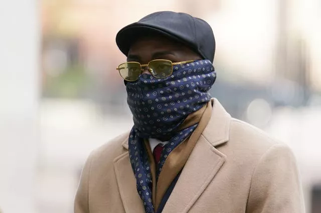 Reality TV star Emmanuel Nwanze, with a scarf covering his mouth and nose, arriving at Westminster Magistrates’ Court