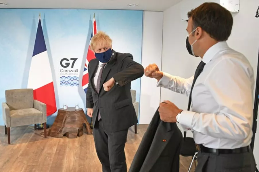Prime Minister Boris Johnson greets French President Emmanuel Macron at the summit 