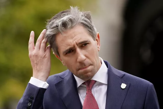 Taoiseach Simon Harris speaks to members of the media outside the Government Buildings in Dublin